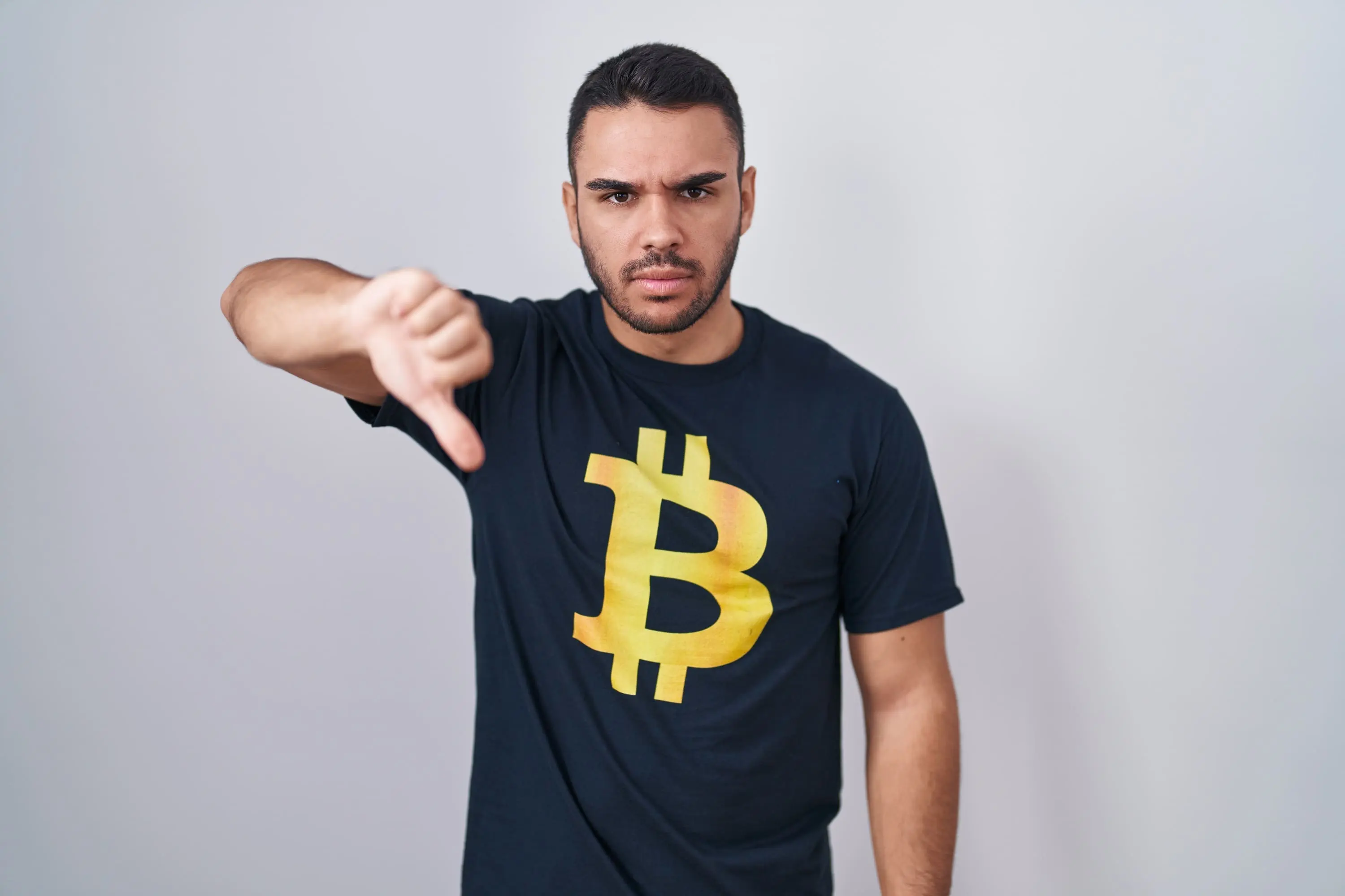 young-hispanic-man-wearing-bitcoin-t-shirt-looking-unhappy-angry-showing-rejection-negative-w...webp