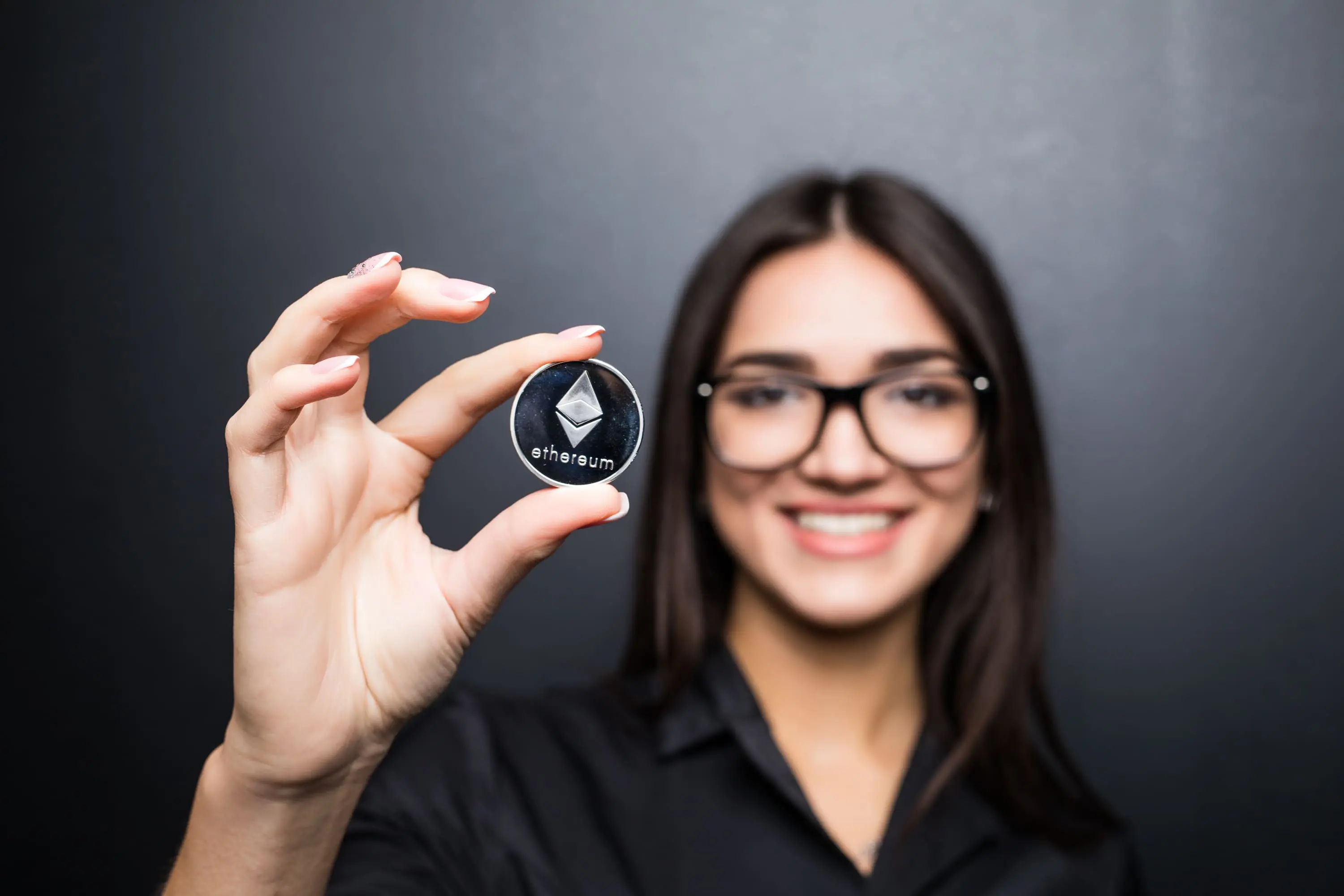 young-business-woman-glasses-with-litecoin-hands-isolated-black-wall (1).webp