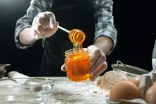 professional-male-cook-sprinkles-dough-with-flour-preapares-bakes-bread-kitchen-table (1).webp